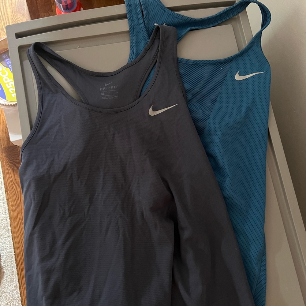 Two Nike running tops
